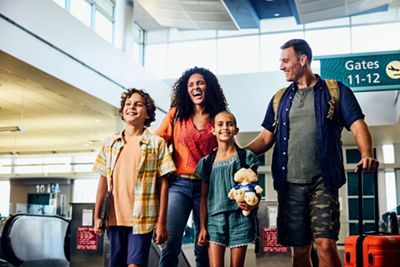 Family walking to airport gate