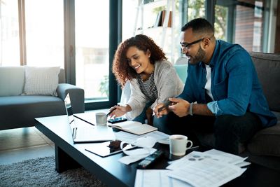 Shot of a young couple planning their budget together at home