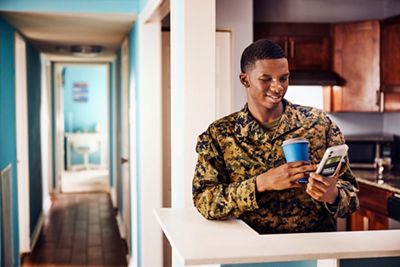 Military man texting on cell phone